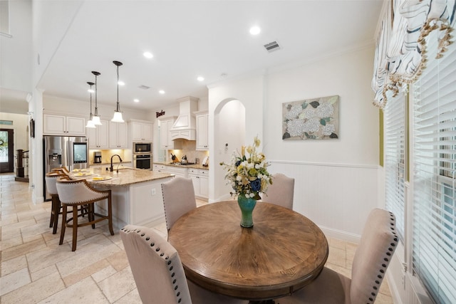 dining room featuring crown molding, stone tile flooring, visible vents, and recessed lighting