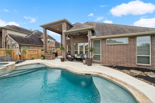 view of pool with a pool with connected hot tub, a patio area, a fenced backyard, and an outdoor living space