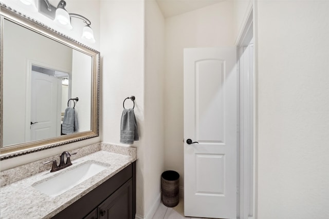 bathroom with baseboards and vanity