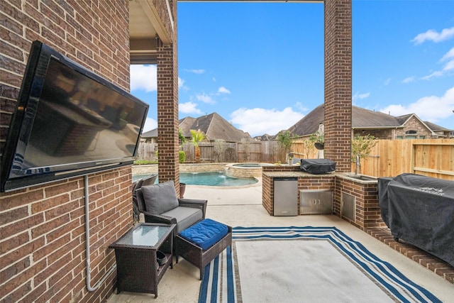 view of patio with a pool with connected hot tub, a fenced backyard, and area for grilling