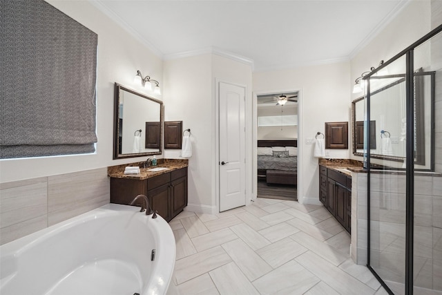 ensuite bathroom featuring ornamental molding, connected bathroom, vanity, and a bathing tub