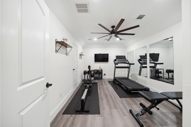 workout room with visible vents, ceiling fan, baseboards, and wood finished floors