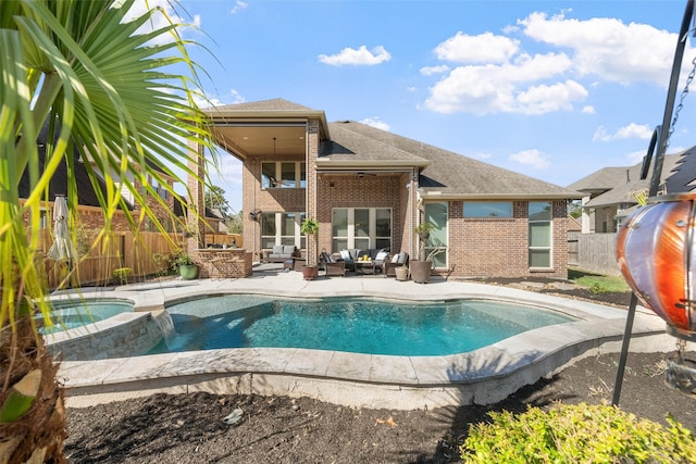 view of pool with a pool with connected hot tub, a fenced backyard, a patio, and an outdoor hangout area