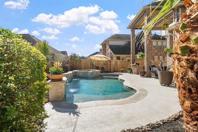 view of pool featuring a patio, a fenced backyard, and a pool with connected hot tub