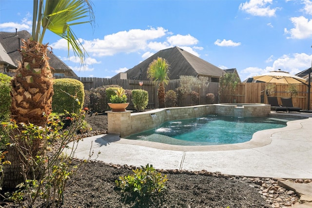 view of pool featuring a fenced backyard, a pool with connected hot tub, and a patio