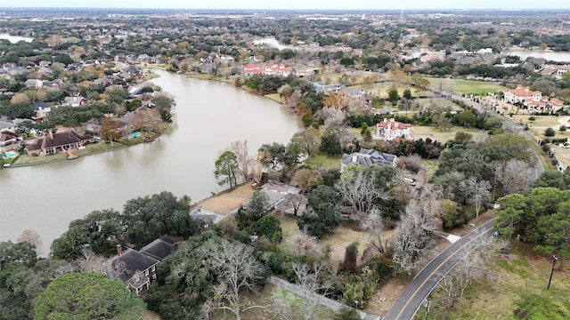 drone / aerial view featuring a water view and a residential view