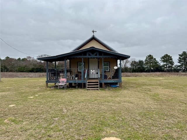 back of property with a porch and a lawn