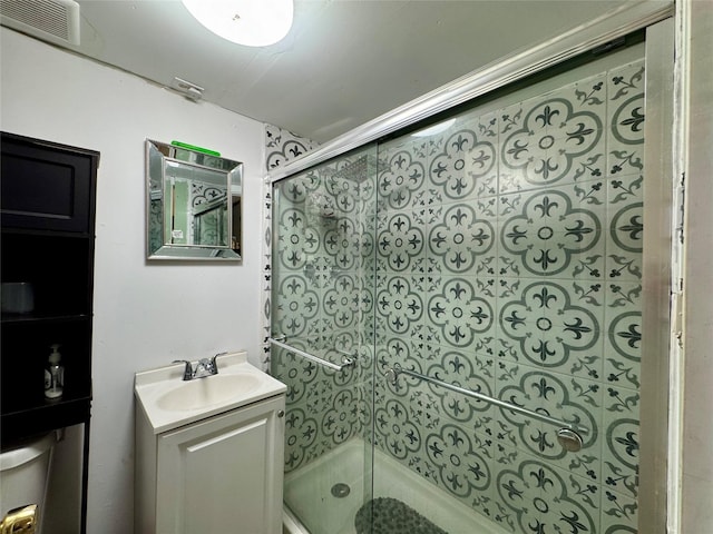 bathroom featuring a stall shower, visible vents, and vanity