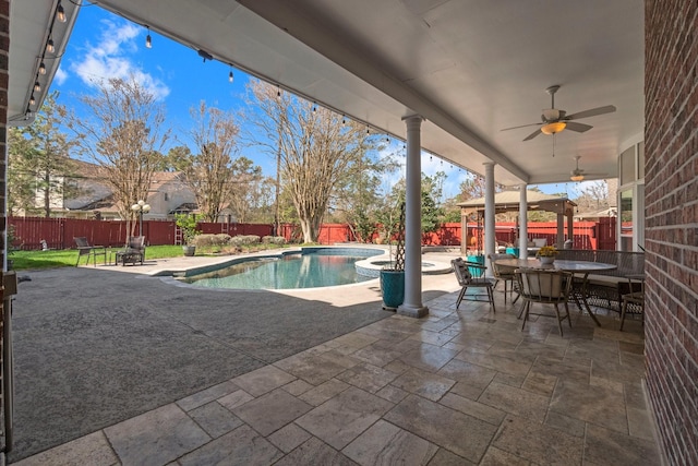 view of pool featuring outdoor dining area, a fenced backyard, ceiling fan, and a patio