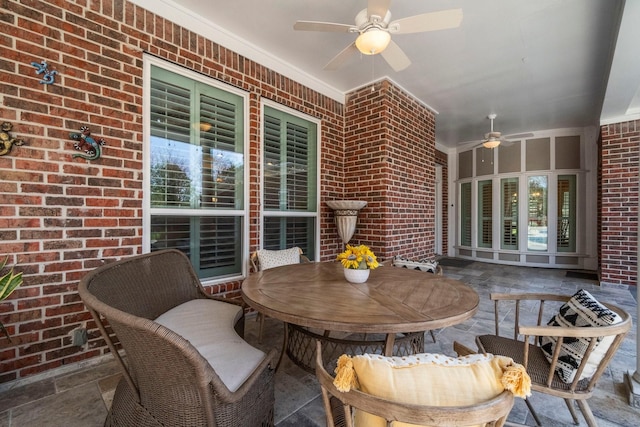 view of patio with a ceiling fan and outdoor dining area