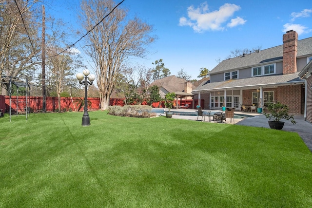 view of yard with a patio, fence, and a fenced in pool