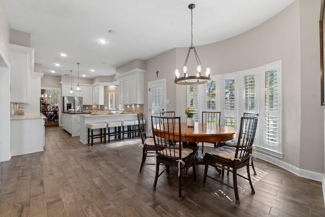 dining space featuring an inviting chandelier, baseboards, dark wood-style flooring, and recessed lighting