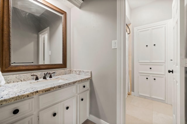 bathroom featuring vanity, baseboards, and tile patterned floors