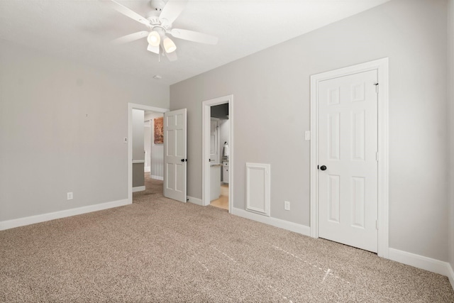 unfurnished bedroom featuring ceiling fan, carpet floors, connected bathroom, and baseboards