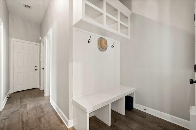 mudroom with visible vents, baseboards, and wood finished floors