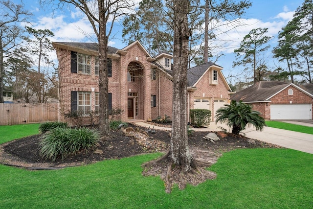 view of front facade featuring concrete driveway, brick siding, a front yard, and fence