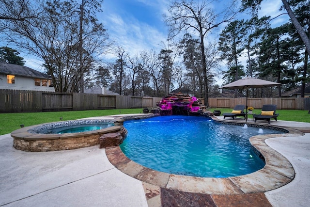 view of swimming pool featuring a fenced backyard, a pool with connected hot tub, a patio, and a yard