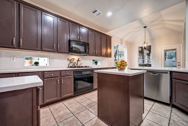 kitchen featuring lofted ceiling, a kitchen island, visible vents, light countertops, and black appliances