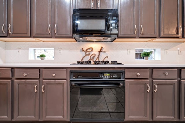 kitchen with black appliances, backsplash, and light countertops