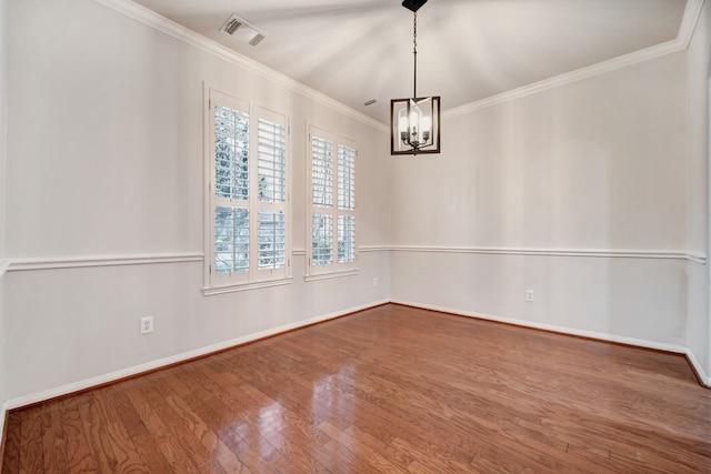 unfurnished room with baseboards, wood finished floors, visible vents, and crown molding