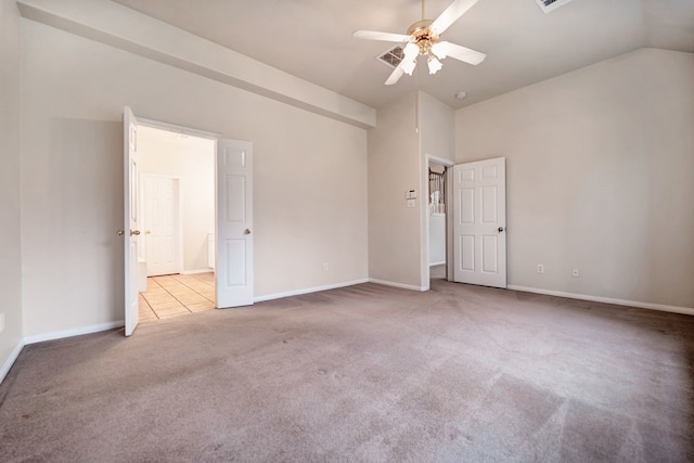 unfurnished room featuring carpet, baseboards, vaulted ceiling, and a ceiling fan