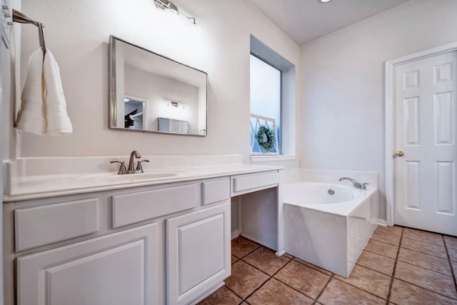 full bathroom featuring tile patterned flooring, a bath, and vanity