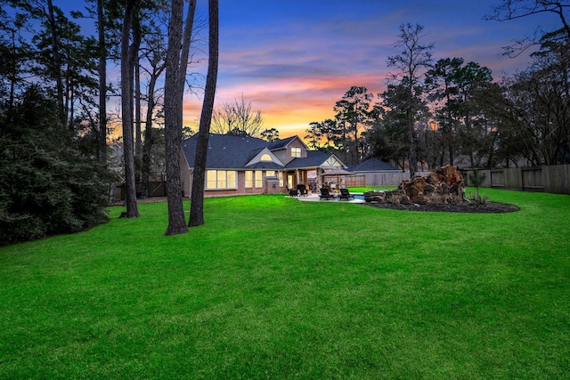 view of yard with fence and a patio