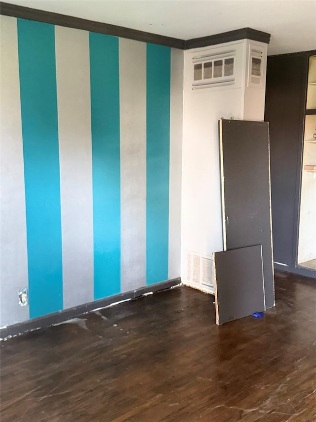 empty room featuring wood finished floors and visible vents