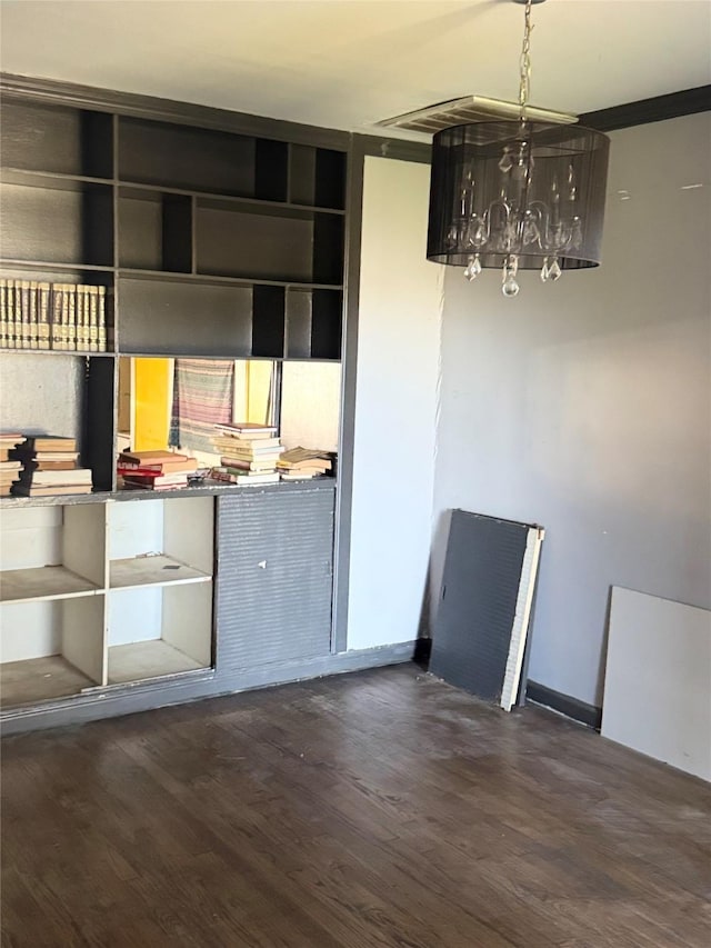 unfurnished dining area featuring dark wood-style floors, a chandelier, and baseboards