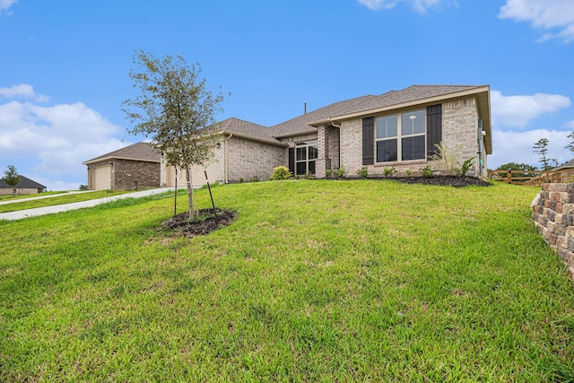 single story home featuring an attached garage, brick siding, a shingled roof, and a front yard