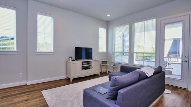 living room featuring dark wood-style flooring, recessed lighting, and baseboards