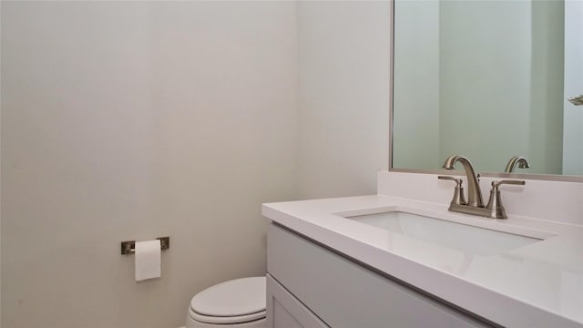 half bathroom with toilet and vanity