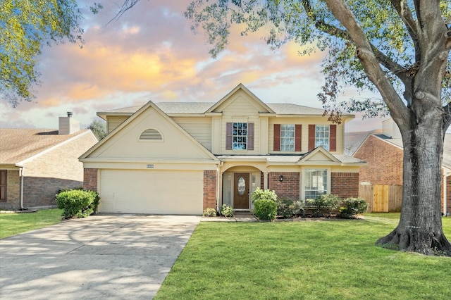 traditional home with an attached garage, brick siding, fence, concrete driveway, and a lawn