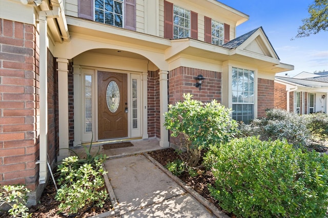 property entrance with brick siding