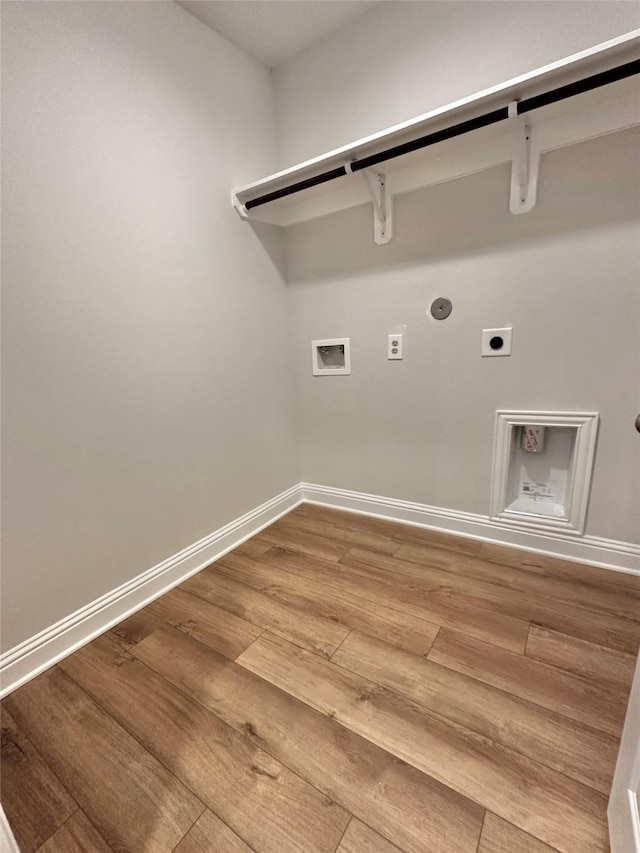 laundry area featuring laundry area, baseboards, wood finished floors, hookup for a washing machine, and electric dryer hookup