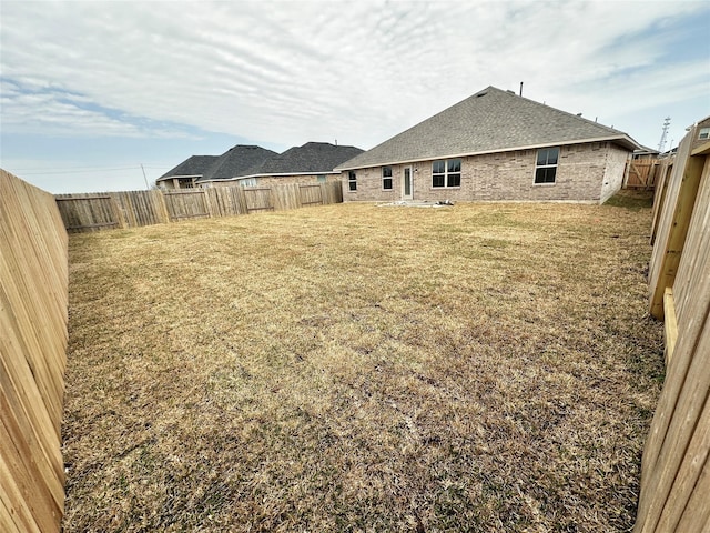 view of yard with a fenced backyard