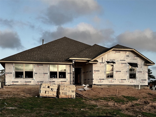 back of property with roof with shingles