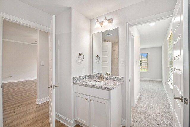 4427 Leslies Way, Dickinson, TX 77539 - bathroom with baseboards, vanity, and wood finished floors