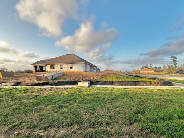 view of side of home featuring a lawn