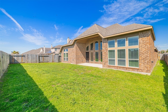 23403 Clark Arbor Ln, Katy, TX 77493 - back of house featuring brick siding, a lawn, and a fenced backyard