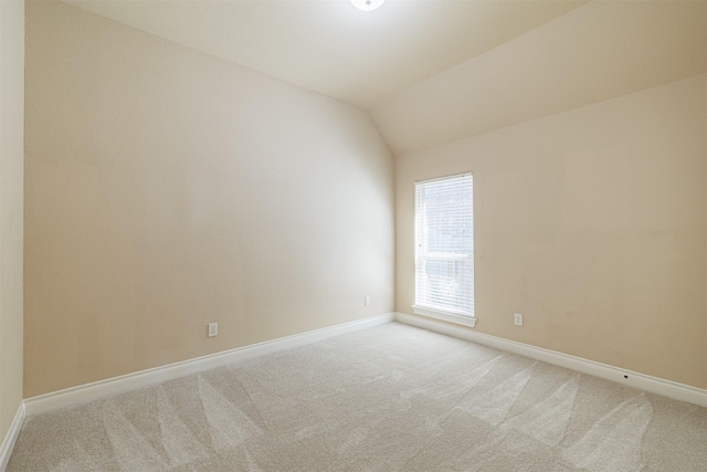23403 Clark Arbor Ln, Katy, TX 77493 - empty room featuring lofted ceiling, light colored carpet, and baseboards