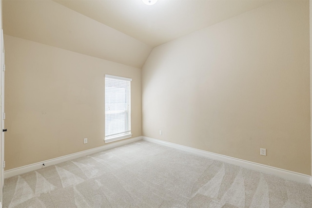 23403 Clark Arbor Ln, Katy, TX 77493 - spare room featuring lofted ceiling, baseboards, and light colored carpet