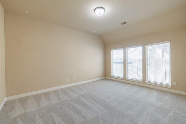 23403 Clark Arbor Ln, Katy, TX 77493 - spare room with light carpet, baseboards, visible vents, and vaulted ceiling