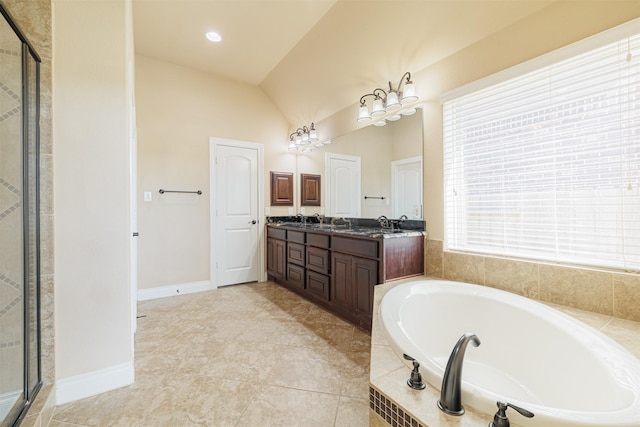 23403 Clark Arbor Ln, Katy, TX 77493 - bathroom with double vanity, baseboards, a garden tub, vaulted ceiling, and a shower stall