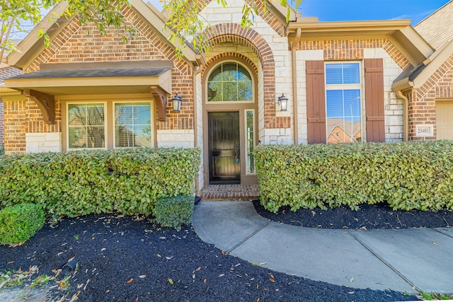 view of exterior entry with brick siding