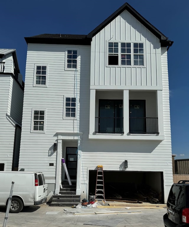 view of front facade with entry steps and board and batten siding