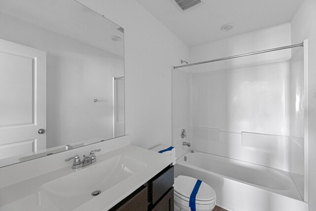 full bath with visible vents, shower / tub combination, vanity, and toilet