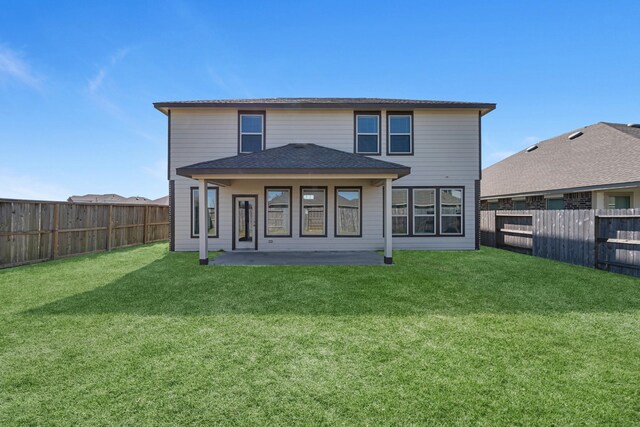 rear view of house with a patio area, a fenced backyard, and a lawn