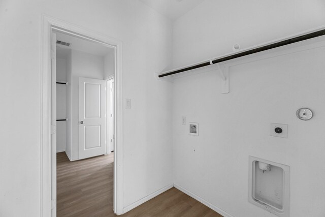 laundry room featuring laundry area, visible vents, wood finished floors, hookup for a washing machine, and hookup for an electric dryer