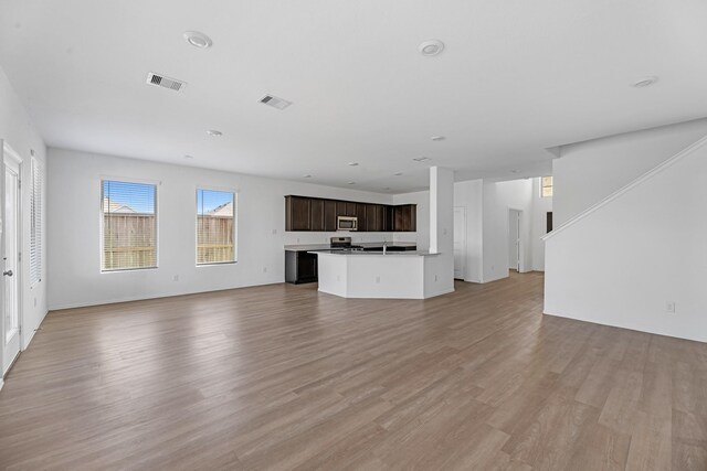 unfurnished living room with visible vents and light wood-style flooring